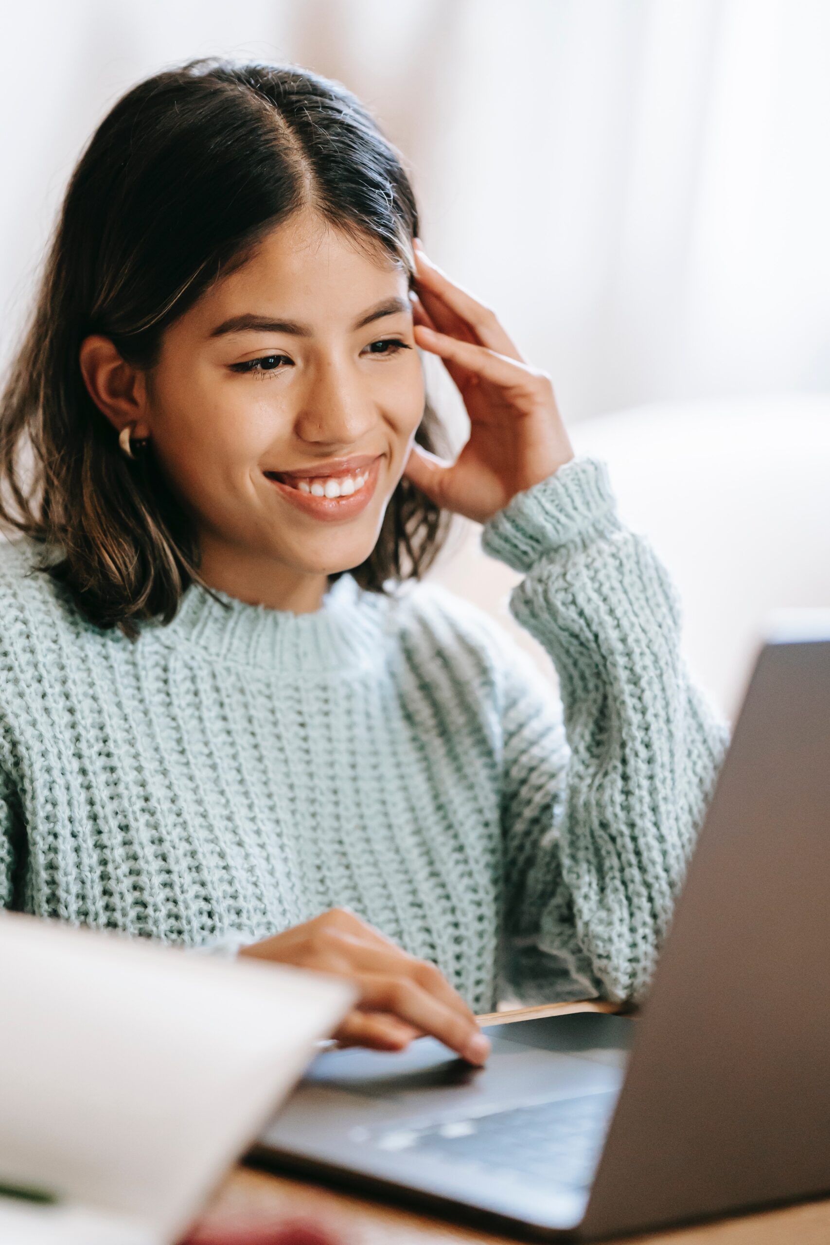 Woman using a laptop while receiving private outpatient treatment for alcohol use disorder