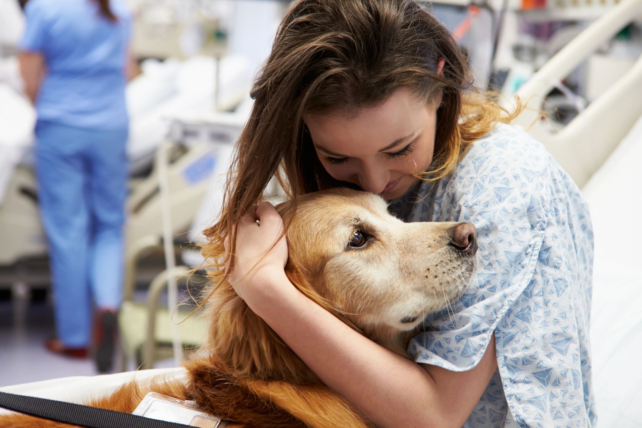 girl hugging golden retriever